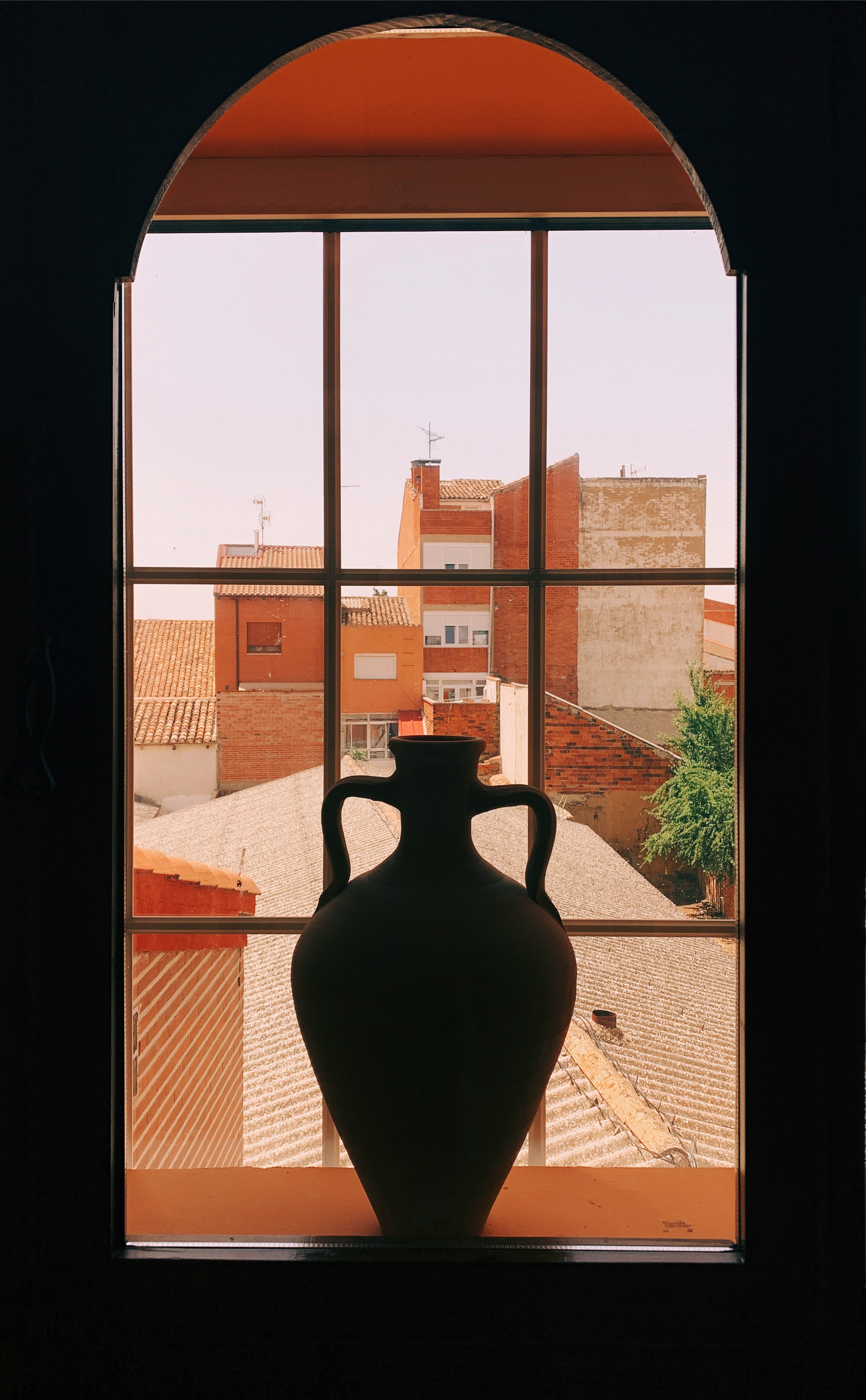 white ceramic vase on window